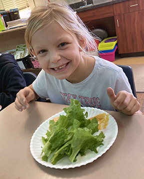 child eating lettuce